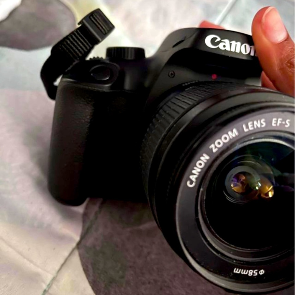 Canon eos t100 . Great for picture and videos . Loved it for vlogging!